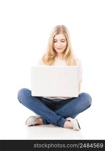 Beautiful blonde woman working with a laptop, isolated over white background