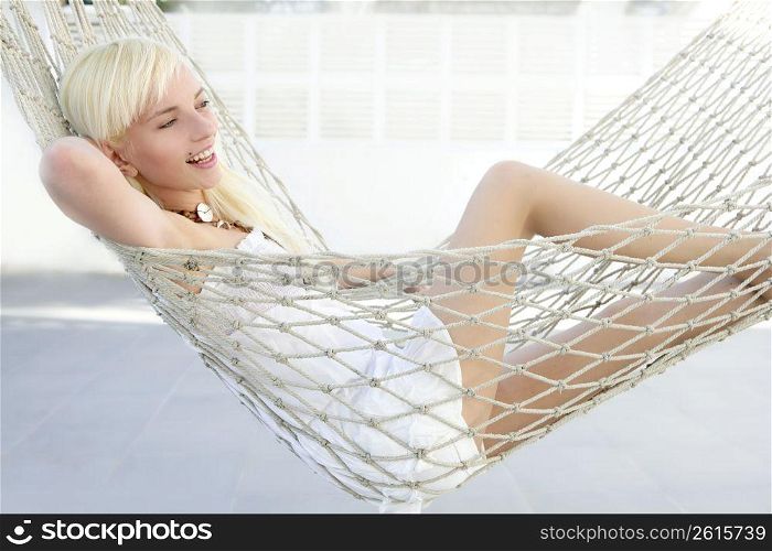 beautiful blonde young girl relaxed on hammock profile