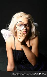 beautiful blondie girl with magnifier looka at you