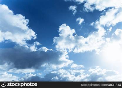 Beautiful blue cloudy sky, sun shine, abstract natural background, cloudscape, fluffy cumulonimbus clouds, spring nature