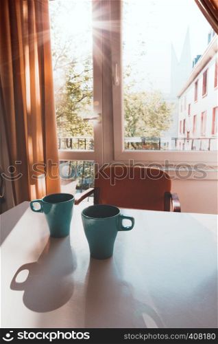 beautiful blue cups with tea on the table in the early morning