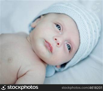 Beautiful blue-eyed baby with hat of the same color