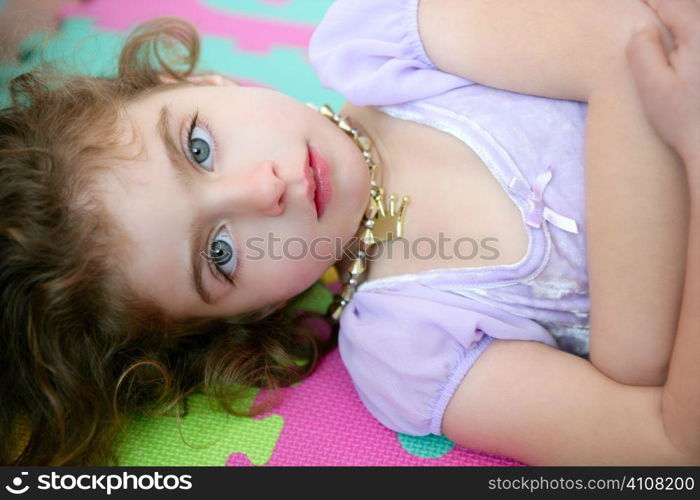 Beautiful blue eyes little girl liying on the floor