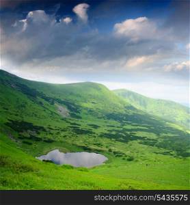 "Beautiful blue sky and lake "Nesamovyte" high up in Carpathian mountains"