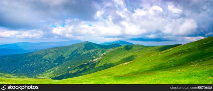 Beautiful blue sky and meadows in Carpathian mountains. Panoramic view