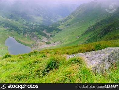 "Beautiful blue sky and rock high up in Carpathian mountains. Lake "Brebeneskul""