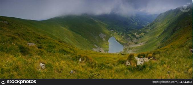 "Beautiful blue sky and rock high up in Carpathian mountains. Lake "Brebeneskul" panorama"