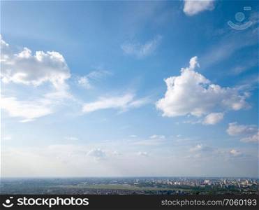 Beautiful blue sky with white clouds, panorama of a large modern city of Kiev on a spring sunny day, Ukraine. Photo from the drone. A large modern city of Kiev against the blue sky, a panorama of the city,Ukraine. Photo from the drone