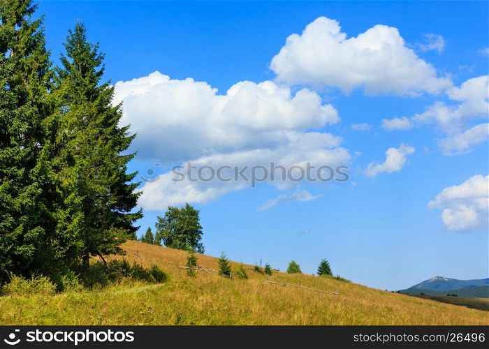 Beautiful blue sky with white cumulus clouds over summer Carpathian mountain (Ukraine, Verkhovyna district, Ivano-Frankivsk region).