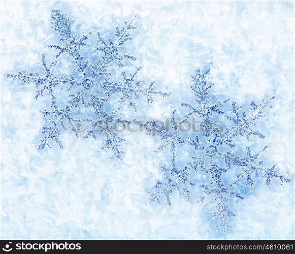 Beautiful blue snowflakes isolated on snow, winter holiday background