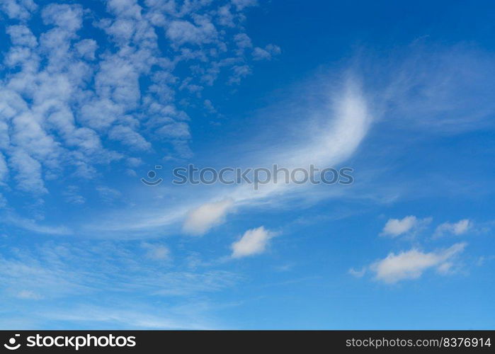 Beautiful blue summer sky and white cirrocumulus clouds background. Cloudscape background. Blue sky and fluffy white clouds on a sunny day. Nice weather in summer. Beauty in nature. Summer sunny sky.