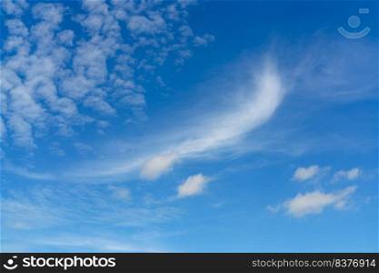 Beautiful blue summer sky and white cirrocumulus clouds background. Cloudscape background. Blue sky and fluffy white clouds on a sunny day. Nice weather in summer. Beauty in nature. Summer sunny sky.