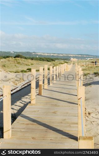 beautiful boardwalk through the dunes entering local beach