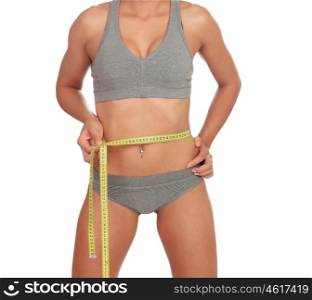 Beautiful body girl measuring her waist isolated on a white background