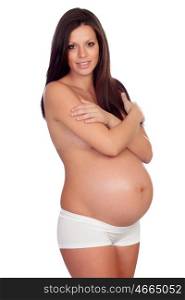 Beautiful body of a pregnant woman covering her bare chest with arms isolated on a white background