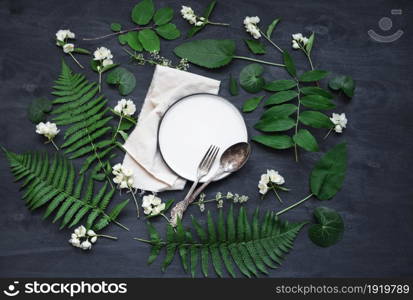 Beautiful boho spring table set up mockup with wild flower and plant decoration. Trendy flat lay top view photo.. Beautiful boho spring table set up mockup with wild flower and plant decoration.