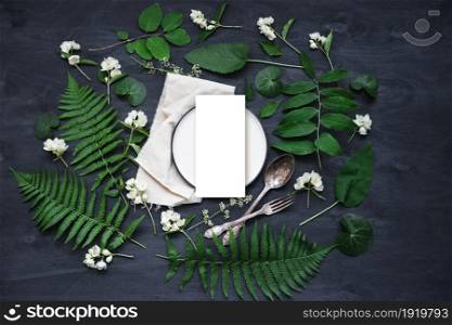Beautiful boho spring table set up mockup with wild flower and plant decoration. Trendy flat lay top view photo.. Beautiful boho spring table set up mockup with wild flower and plant decoration.