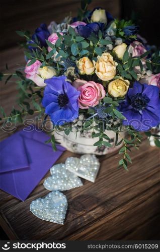 beautiful bouquet flowers and hearts at wooden background. beautiful bouquet flowers and hearts