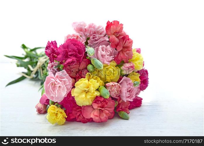 beautiful bouquet of colorful flowers carnation on a white table