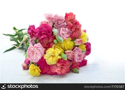beautiful bouquet of colorful flowers carnation on a white table