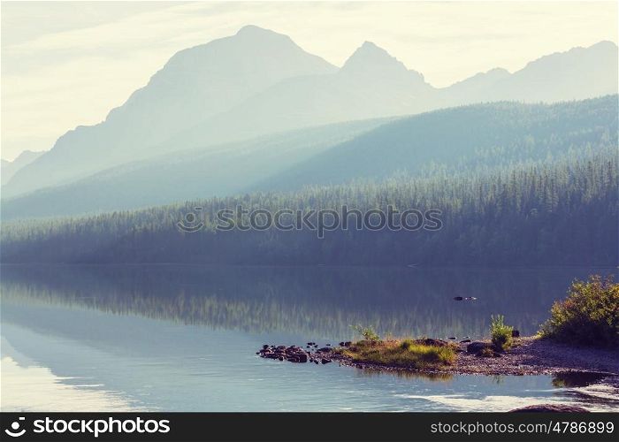 Beautiful Bowman lake with reflection of the spectacular mountains in Glacier National Park, Montana, USA. Instagram filter.