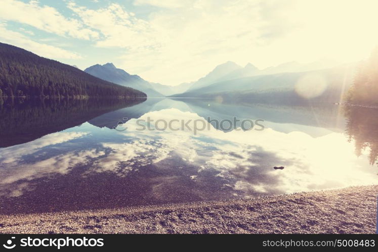 Beautiful Bowman lake with reflection of the spectacular mountains in Glacier National Park, Montana, USA. Instagram filter.