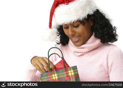 beautiful brazilian girl with Santa hat receiving a gift