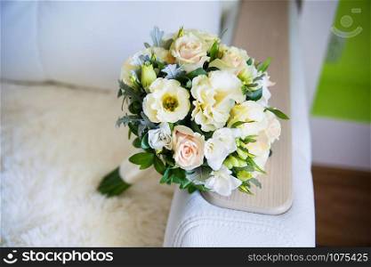 beautiful bridal bouquet lying on the sofa. beautiful bridal bouquet lying on sofa
