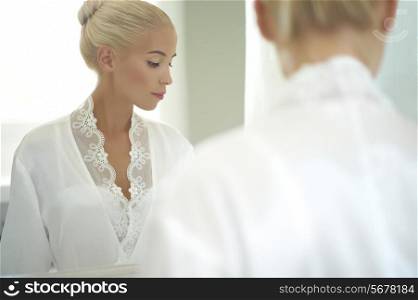 Beautiful bride in the mirror. Fashion art photo