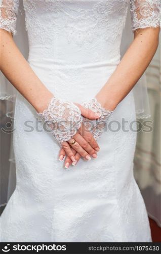Beautiful bride&rsquo;s hands in white gloves close-up. Beautiful bride&rsquo;s hands in white gloves closeup