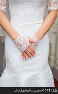 Beautiful bride&rsquo;s hands in white gloves close-up. Beautiful bride&rsquo;s hands in white gloves closeup