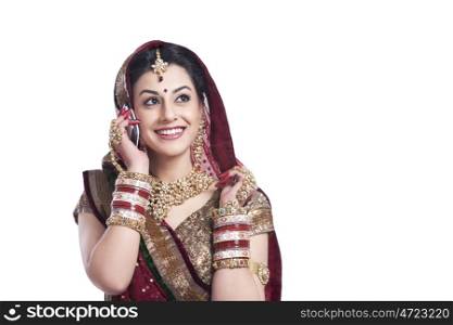 Beautiful bride talking on a mobile phone