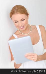 Beautiful bride using digital tablet