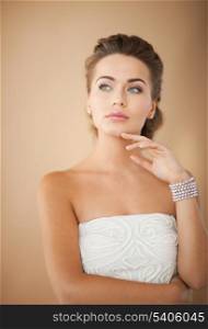 beautiful bride wearing pearl earrings and bracelet