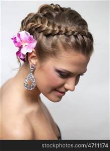 Beautiful bride with fashion wedding hairstyle - on gray background