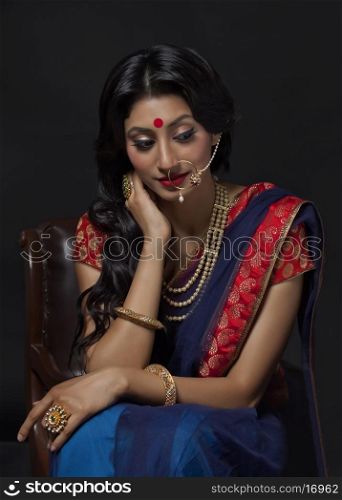 Beautiful bride with jewelery sitting