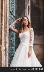 Beautiful bride with make up in long white dress outdoor. Portrait of the bride with long hair. Beautiful bride with make up in long white dress outdoor. Portrait of the bride with long hair.