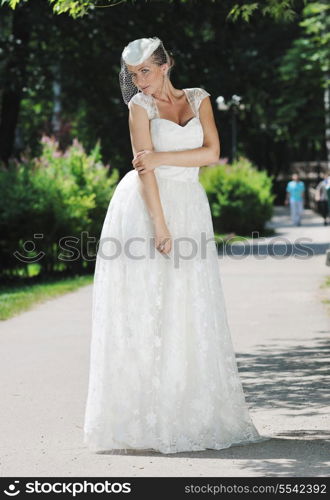 beautiful bride woman people in fashion wedding dress posing outdoor in bright park