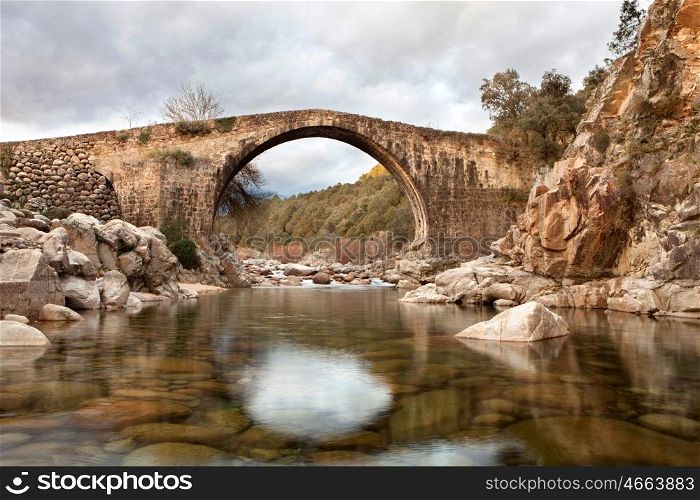 Beautiful bridge with a clear river in mountain of Spain