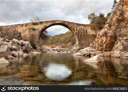 Beautiful bridge with a clear river in mountain of Spain