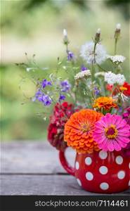 beautiful bright bouquet of wildflowers in a vase in the garden