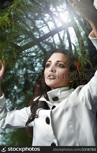 Beautiful brunette collecting leafs