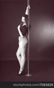 Beautiful brunette dancing on a pole