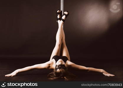 Beautiful brunette dancing on a pole