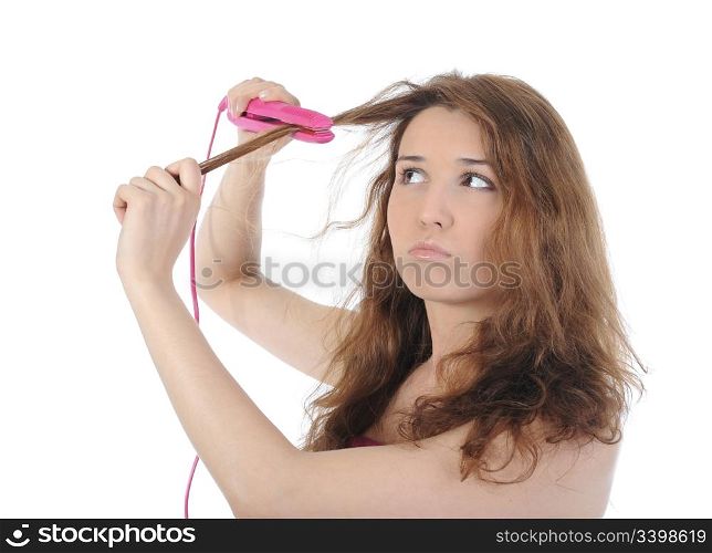 Beautiful brunette doing her hair. Isolated on white background