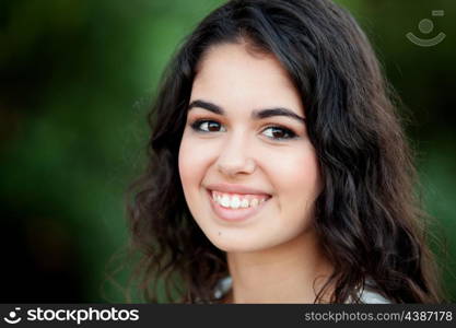 Beautiful brunette girl relaxing in the park wiht many plants of background