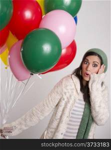 Beautiful Brunette hold a bunch of colorful balloons