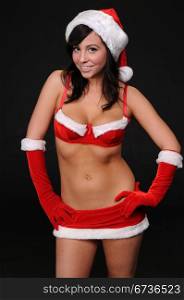 Beautiful brunette in a sexy Santa&rsquo;s helper outfit