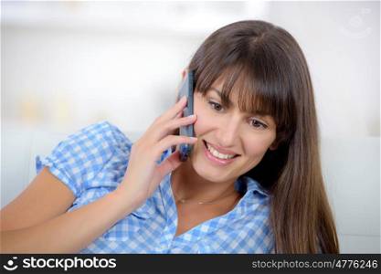 beautiful brunette on the phone at home