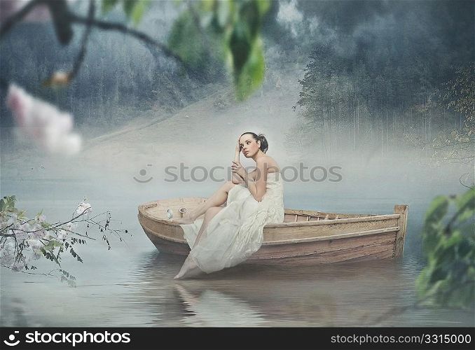 Beautiful brunette posing over beautiful romantic landscape
